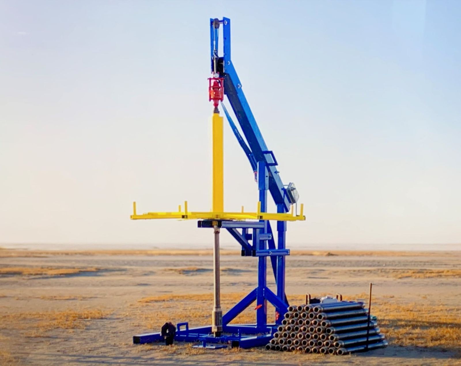 The blue Village Drill rig standing on open plains